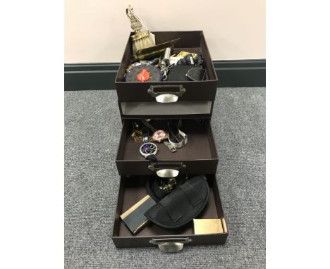 A three drawer desk top miniature chest containing watches, brass ware, match book, cased English Chinese dictionary, miniatu