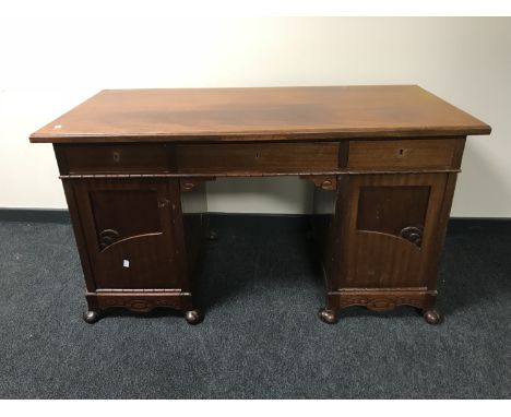 An antique mahogany twin pedestal desk 