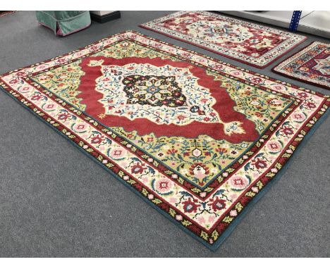 A woollen floral carpet on red ground
