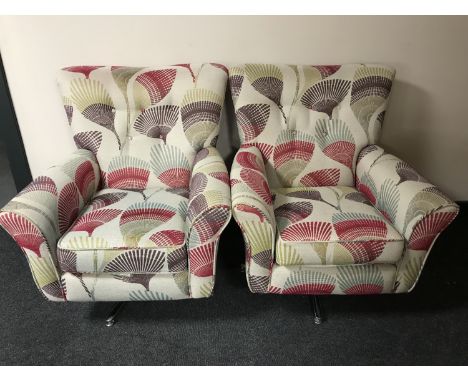 A pair of House of Fraser swivel armchairs upholstered in a button fabric RRP £1200 