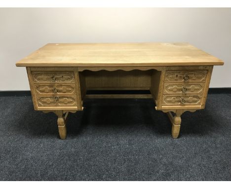 A blond oak twin pedestal desk