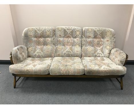 A wood framed Ercol three seater settee 