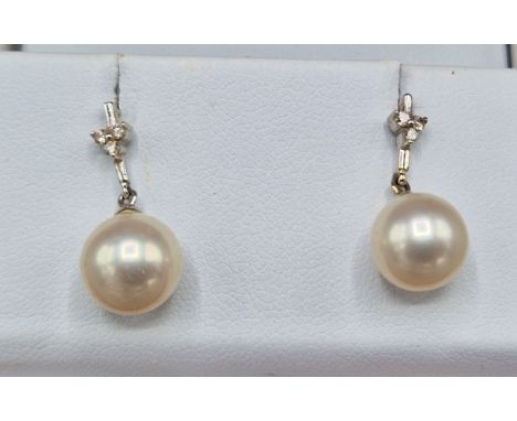 A pair of 18ct white gold pearl and diamond set ear studs 