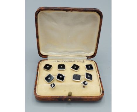 A 9ct white gold black enamel and diamond cufflink and dress stud set within fitted case 