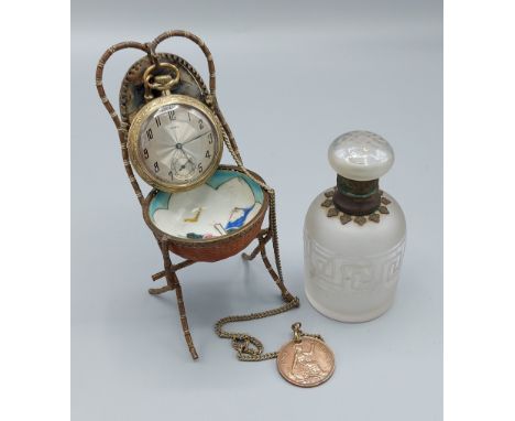 A Victorian brass pocket watch stand, together with a Noxil pocket watch with chain and a glass scent bottle 