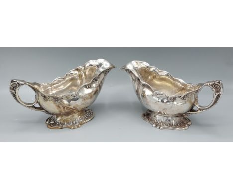 A pair of 830 silver sauce jugs of shaped form, 18ozs 