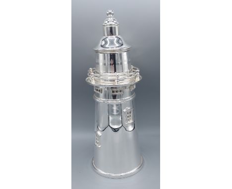 A silver plated cocktail shaker in the form of a lighthouse, 34cms tall 