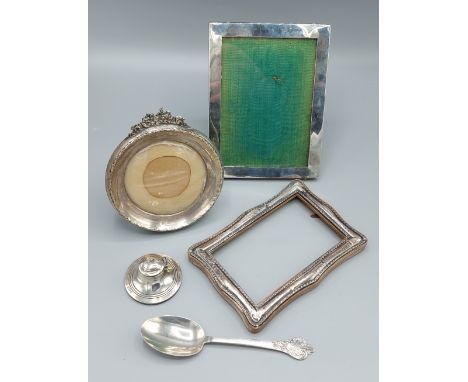 A Birmingham silver miniature Capstan inkwell together with three silver photograph frames and a Sheffield silver spoon 