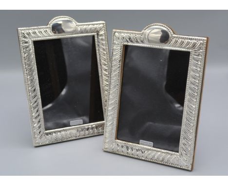 A pair of 925 silver photograph frames of rectangular form with arched cresting, 19.5cms X14cms 