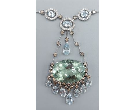 An 18ct white gold Diamond and Aquamarine necklace, the large oval stone with seven drops with diamonds above, the linked cha