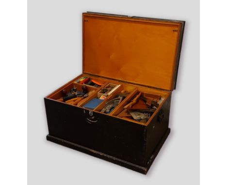 A large wooden tool chest containing a collection of tools 