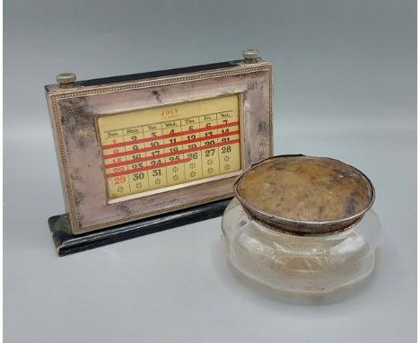 A London silver cased calendar by Asprey together with a London silver and tortoiseshell mounted glass dressing table bottle 