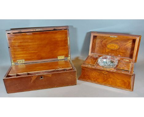 A 19th Century mahogany sarcophagus shaped tea caddy, the hinged top enclosing a fitted interior with glass blending bowl and