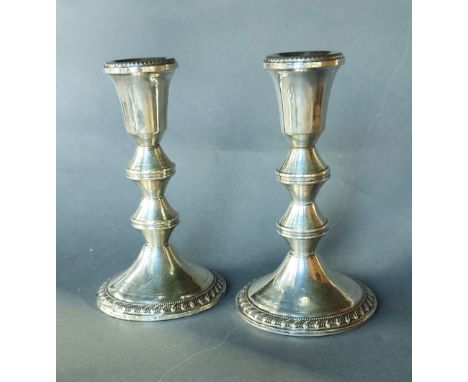 A pair of Sterling silver candlesticks, 15.5cms tall 