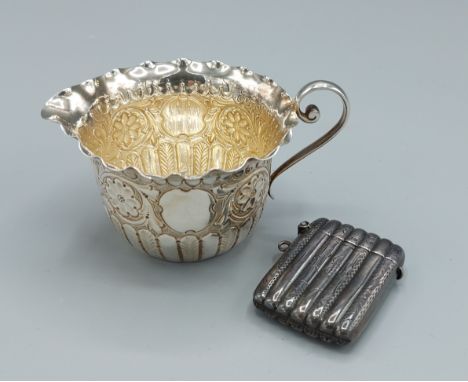 A Victorian small cream jug, Sheffield 1889 together with a Birmingham silver Vesta case of ribbed form 