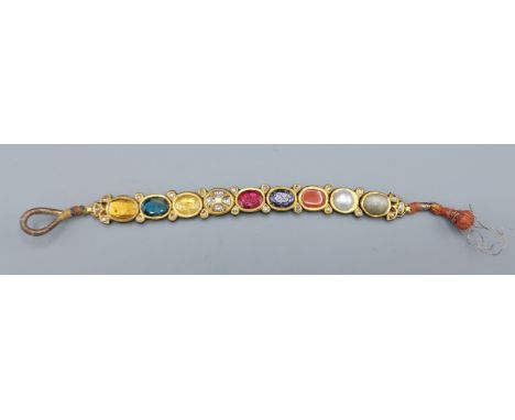 A Mughal yellow metal bracelet set with diamonds and semi precious stones, with enamel decoration to the reverse, 24.5gms, 19