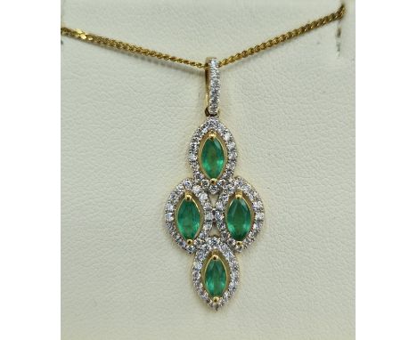 An 18ct gold pendant set with four emeralds surrounded by diamonds with a 925 silver chain, 32mm by 13mm 