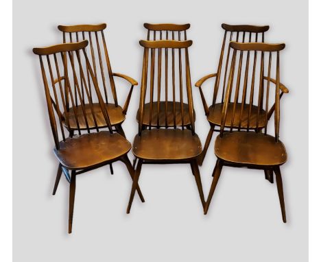 A set of six Ercol stick back dining chairs comprising two armchairs and four single chairs 