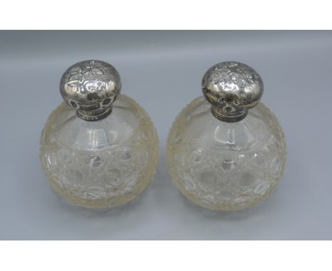 A pair of Edwardian silver and cut glass large scent bottles, decorated with whispers, Birmingham 1906, 13cms tall 