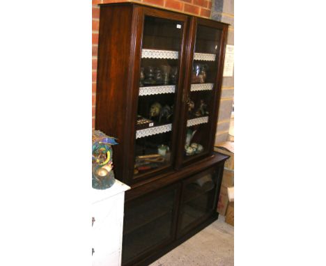 A two section mahogany display cabinet