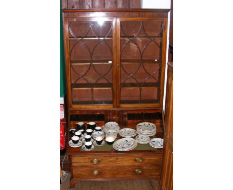 A Georgian bureau bookcase with fitted and inlaid interior, having two short and three long graduated drawers, standing on sh