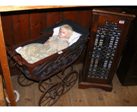 Ceramic doll in pram, together with antique style CD cabinet containing numerous CD's