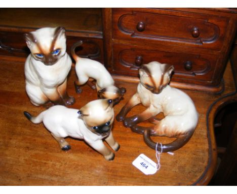 Four ceramic cat ornaments