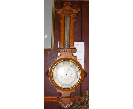 An oak cased aneroid wall barometer/thermometer