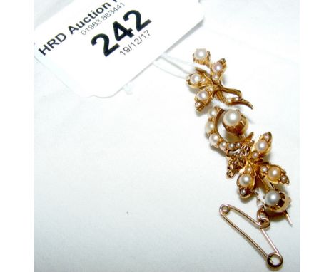 An Edwardian seed pearl crescent brooch in gold setting