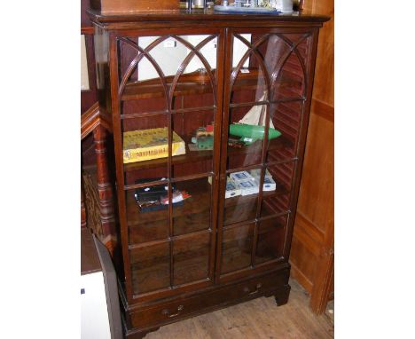 A two door display cabinet with drawer to base