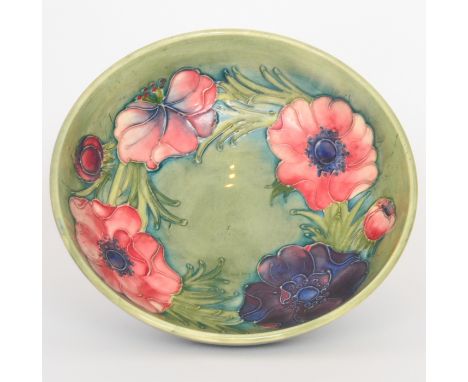 Walter Moorcroft - Anemone - A footed bowl decorated with a band of tonal pink and purple flowers over a green wash ground, i