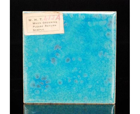 Ruskin Pottery - A 3in dust pressed sample tile decorated with a mottled blue glaze with purple and green spotting, retains p