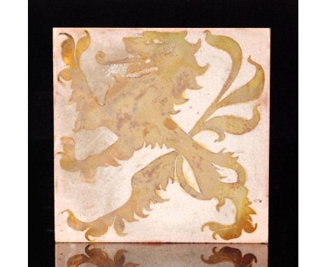 Pilkington's - A 6in plastic clay lustre tile decorated with a low relief heraldic dragon in a gold lustre against a white gr
