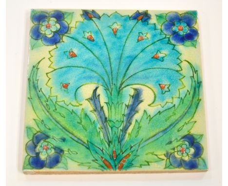 John Chambers - Pilkington's - An early 20th Century 8in plastic clay tile decorated with a Persian design with a large blue 