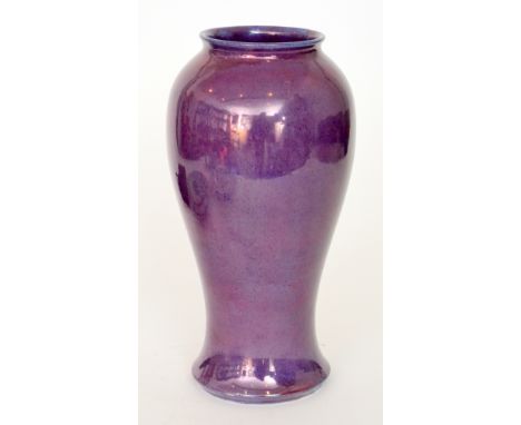 Moorcroft Pottery - A baluster vase of footed form decorated in a flambe purple lustre glaze with blue spotting, unmarked, he