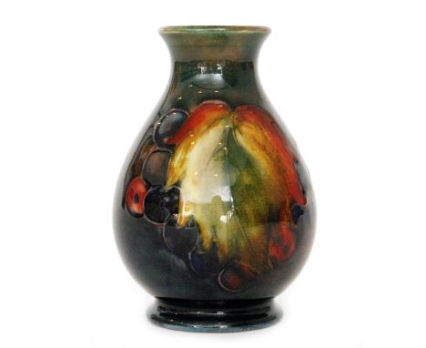 William Moorcroft - Flambe Leaf and Berry - A small baluster form vase decorated with autumnal leaves and berries with flambe