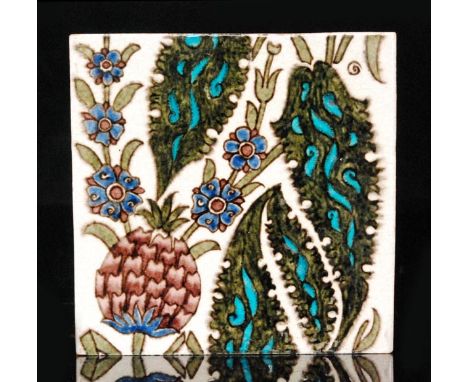 William de Morgan - Merton Abbey - Manchester - A 6in plastic clay tile decorated with stylised Persian type leaves, blue flo