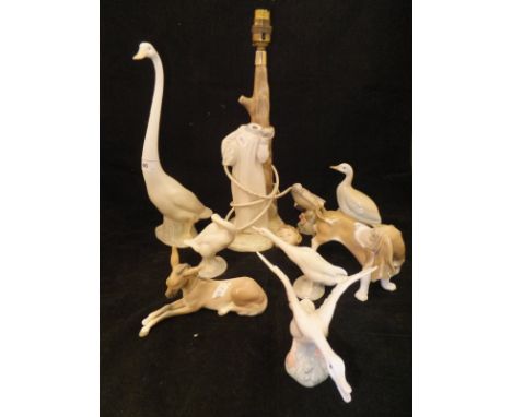 A collection of five various Lladro figures including Bassett hound, donkey, two geese and a swan, together with a Lladro sty