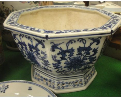 A Chinese blue and white octagonal jardinier with scrolling foliate decoration on a pierced spreading foot, together with an 