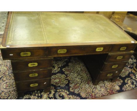 A military style mahogany pedestal partner's desk of nine drawers and green leather inset top, raised on bracket feet CONDITI