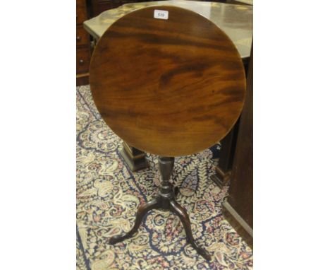 An early 19th Century mahogany occasional table, the single piece circular snap top on a turned pedestal to cabriole tripod b