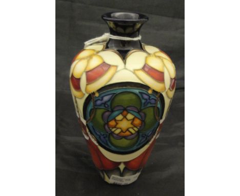 A modern Moorcroft vase bearing label inscribed "Moorcroft Original Trial Vase Christmas Star", stamped and dated to the base