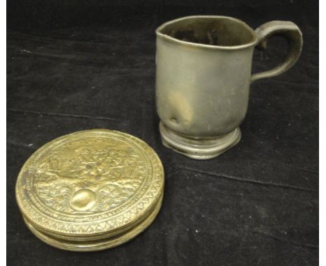 An 18th Century Dutch embossed brass circular tobacco box, the centre field decorated with monkey playing the fiddle to a gro