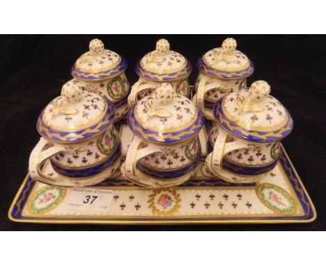 An early 20th Century Dresden six place lidded cup set of baluster form with all-over floral painted and gilt decoration by C