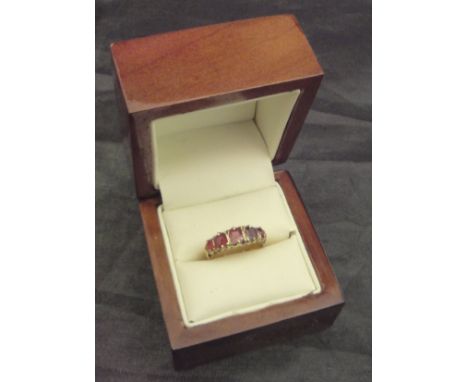 A 9 carat gold and ruby set dress ring