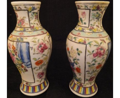 A pair of Chinese polychrome decorated baluster shaped vases, each with panels of birds amongst blossoming foliage  CONDITION