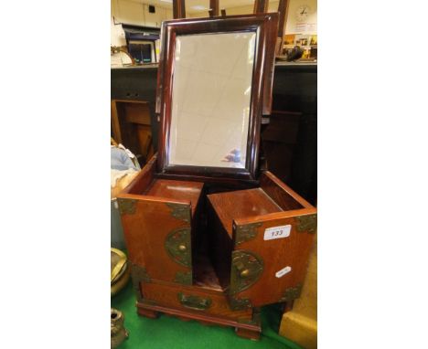 A Chinese elm and brass bound dressing table chest, the rising top with mirror opening to reveal a multi-drawer interior over