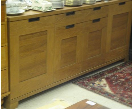 A modern teak sideboard with four cupboard doors and two drawers to simple stile feet CONDITION REPORTS Has general wear and 