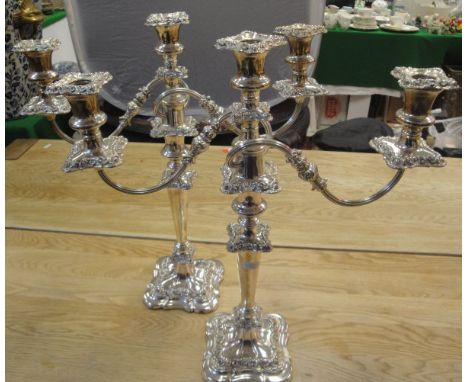 A pair of plated on copper two branch three light candelabra