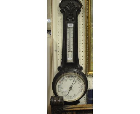 A Victorian carved oak cased aneroid barometer thermometer